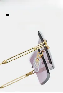 Detail view of gold metal hinges and purple gradient lenses on rimless sunglasses