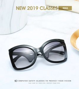 Detail view of large black frame sunglasses with gradient lenses and temple specifications