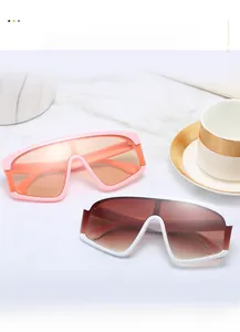 Detail of oversized shield sunglasses on marble with vintage frames and colored lenses