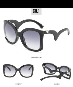 Detail view of large frame sunglasses with purple gradient lenses and metal accents