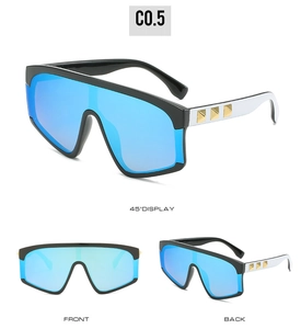 Detail of blue mirrored lenses and black-and-white frame with gold square rivets on side
