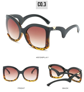Detail view of wave-shaped temples with gold triangular hardware on cat-eye sunglasses