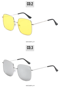 Detail view showing large square sunglasses with silver frames and colorful mirror lenses
