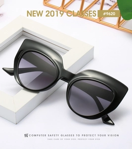 Detail of vintage cat-eye frames with glossy black finish and stylish metal studs