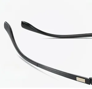 Detail of black glasses temple with gold metal accents and textured non-slip design