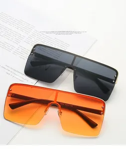 Close-up of oversized flat top sunglasses showing temple details and metal frames