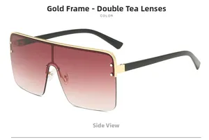Side view of oversized one-piece sunglasses with gold metal frame and gradient brown lenses