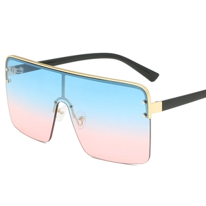 Oversized trendy blue and pink gradient sunglasses with gold metal frame accents