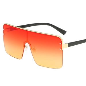 Oversized gradient orange-red sunglasses with gold metal top bar and thick black frames