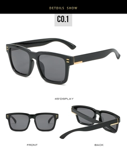 Classic square black sunglasses detail showing gold metal accents and dark grey lenses
