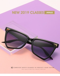 Detail showing gold triangle metal decor and black irregular frame on sunglasses