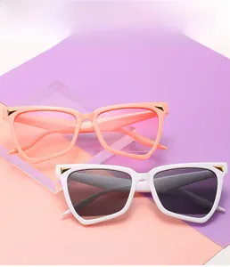 Close-up of stylish irregular cat-eye sunglasses with gold metal corner details