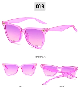 Three-view display of pink oversized cat-eye sunglasses with gold metal corner details