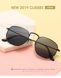 Close-up of vintage black metal polygonal sunglasses on a marble stand with #3548 detail