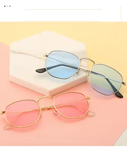 Close-up of geometric polygon sunglasses in blue, pink, and gradient lenses with gold frames