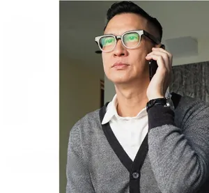 Asian businessman wearing black square frame glasses with metal accents on temples
