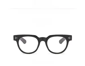 Close-up of shiny black full-rim glasses frame with silver triple stud rivets