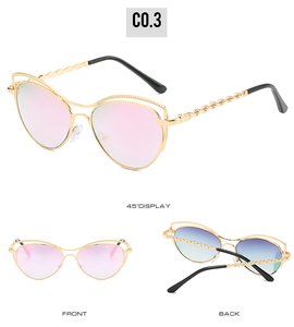 Détail de lunettes œil de chat avec branches en chaîne métallique et verres dégradés roses