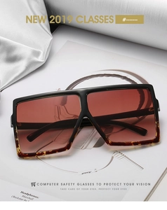Detail of oversized square sunglasses with black and leopard frame on fashion magazine