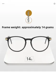 Close-up of black round eyeglass frames weighing 14g on a white digital scale