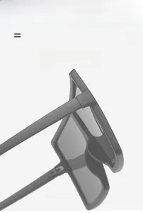 Detail of the metal hinge structure on matte black oversized square frame sunglasses