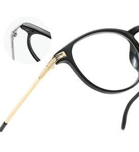 Detail of reinforced metal hinges on round black and gold frame glasses for durability