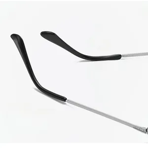 Macro detail of metal eyeglass temples with ergonomic black tips and silver finish