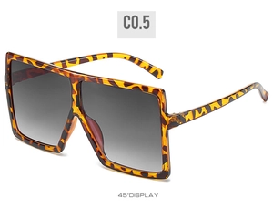 Detail view of square oversized sunglasses in leopard tortoise frame at 45 degree angle