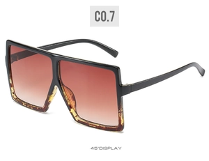 Detail view of oversized square sunglasses with black frame and leopard print accents