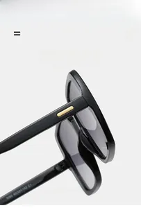 Detail of square black sunglasses temple featuring a sleek gold metal bar accent
