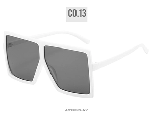 Detailed 45-degree side view of oversized square sunglasses in glossy white finish