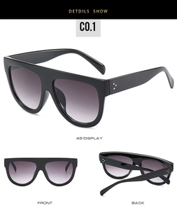 Detail of square oversized black sunglasses featuring silver triple rivet accents and gradient lenses