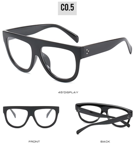 Detail view of black oversized flat top sunglasses with three silver rivets on the frame