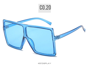 Detail shot of oversized square sunglasses featuring a transparent blue plastic frame