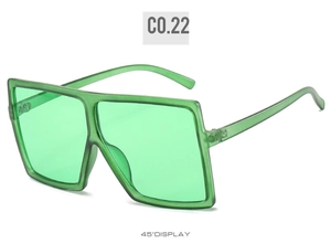 Detailed 45-degree view of oversized square sunglasses in translucent green resin