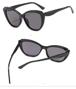 Detail view of black irregular cat eye sunglasses showing the 45 degree side and inner frame