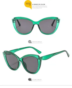 Transparent green glitter cat-eye sunglasses with grey lenses in front and side views