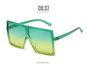 Detail view of large square sunglasses with green transparent frames and gradient lenses