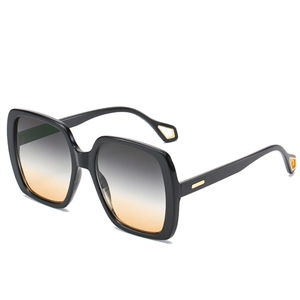 Fashionable oversized square sunglasses with black frames and gradient amber lenses