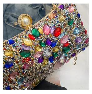 Macro view of luxury evening clutch bag with multi-color rhinestones and pearl clasp