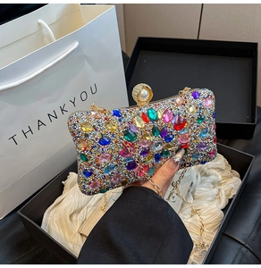 Detail of colorful rhinestone dinner clutch bag with pearl clasp and chain strap