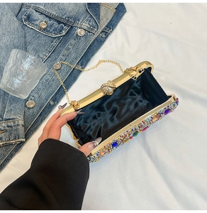 Detail of colorful rhinestone evening bag with gold chain strap and pearl clasp