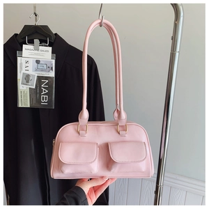 Pink Boston bag detail featuring double front flap pockets and golden metal hardware