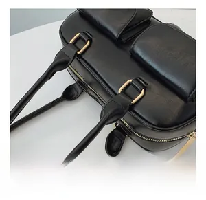 Detailed close-up of premium black leather bowling bag with gold hardware and zipper