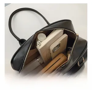 Detail view of the spacious main compartment of the black leather boston handbag