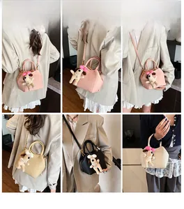 Detail showing various colors of crossbody bags with cute puppy plush pendants