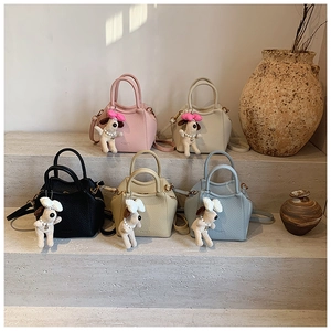 Litchi pattern crossbody bags in five colors with cute plush dog pendants on steps