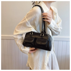 Detail of vintage black bowling bag with golden buckles and front pockets