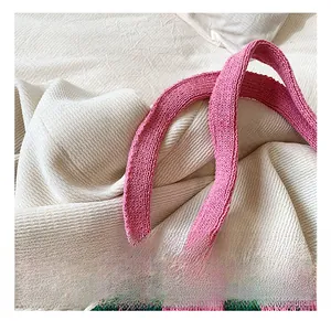 Détail de la poignée en tricot rose fixée au cabas à damier vert et rose pastel