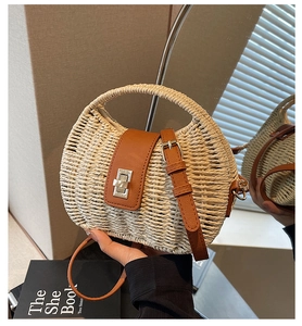 Detail of cream straw handbag with brown leather flap and silver twist lock closure